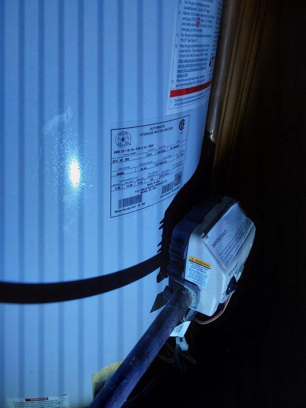 Conducted free estimate for water heater replacement in basement. Evaluated existing 13-year-old tank-style water heater showing signs of age, documented current installation including gas valve assembly, piping connections, and venting configuration. Photographed unit specifications, manufacturer labels, and existing plumbing setup to provide accurate replacement recommendations.