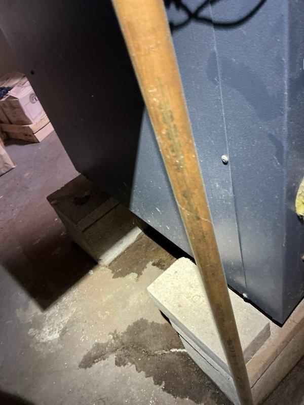 # HVAC Service - Boiler

Responded to service call for boiler leaking hot water from bottom, upper left-hand corner. Upon arrival, parked in back of driveway per customer request and proceeded to inspect the unit. Investigation revealed active water leakage originating from the lower section of the boiler assembly. Documented conditions with photographs showing water accumulation on basement floor with visible staining and moisture damage to surrounding concrete surfaces. The leak source was traced to the upper left-hand corner area of the boiler's lower section, indicating potential failure of internal components, gaskets, or tank integrity. Photographed evidence of water intrusion and assessed the extent of damage to the installation area. Customer was advised of findings and provided recommendations for repair or replacement options based on the age and condition of the unit.
