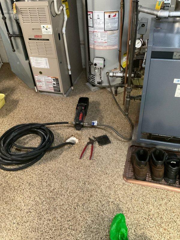 Performed scheduled maintenance on Bradford White water heater in basement utility room. Inspected unit operation, tested temperature and pressure relief valve, checked all copper piping connections and shut-off valves, and verified proper functioning of expansion tank. Documented equipment condition with photos showing all mechanical connections, ductwork, and plumbing infrastructure in satisfactory working order.