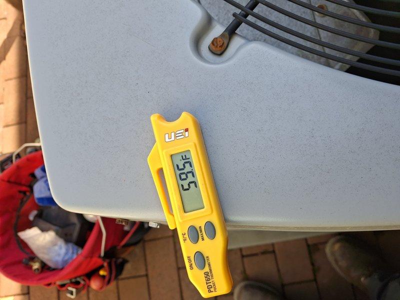 Performed scheduled cooling system tune-up on a 10-year-old air conditioning unit for a home plan member. Upon inspection, discovered evaporator coil completely covered with heavy frost and ice buildup, indicating a system malfunction. Documented the frozen coil condition with photographs showing extensive crystalline ice formation across all coil fins. Measured and recorded superheat reading of 53.5°F using digital refrigerant analyzer, confirming improper refrigerant charge or restricted airflow causing the freeze-up condition. The system was operational but running in a compromised state. Identified this as a critical issue requiring immediate attention to prevent compressor damage and system failure. Recommended allowing coil to thaw completely before further diagnostics to determine root cause, which could include low refrigerant charge due to leak, restricted airflow from dirty filter or blocked return, failed blower motor, or malfunctioning thermostatic expansion valve. System r