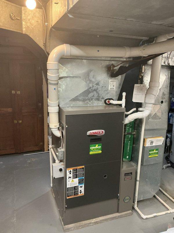 Completed estimate for replacement of existing two-system HVAC setup. Assessed current basement installation featuring Lennox furnace with PVC venting and auxiliary equipment including water heater and filter housing. Evaluated outdoor equipment including Lennox air conditioning unit and secondary AC system positioned on gravel pad against building exterior. Documented existing equipment condition, installation configuration, and replacement requirements for dual-zone cooling system upgrade.