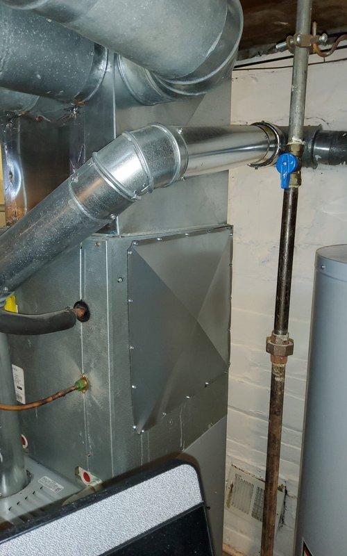 Removed existing Aprilaire whole-house humidifier system from HVAC installation. Disconnected water supply line from copper plumbing assembly and capped connection point. Removed humidifier unit from furnace cabinet and associated mounting hardware. Sealed ductwork penetrations where humidifier was previously installed to prevent air leakage and maintain system efficiency. Inspected surrounding ductwork connections and HVAC equipment to ensure proper operation following removal. All components removed and area left clean and secure.
