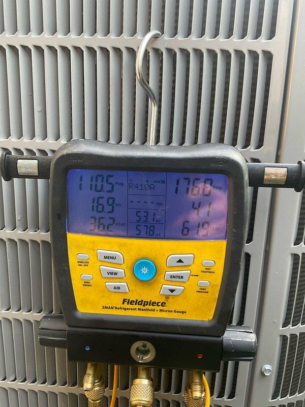 Completed annual preventative maintenance on a 3-year-old Carrier air conditioning system utilizing R-410A refrigerant. Performed comprehensive system inspection including visual examination of indoor air handler unit, verified manufacturer specifications and equipment labeling integrity. Conducted refrigerant system diagnostics using Fieldpiece SMAN manifold gauge, measuring operating pressures at 110.5 PSI suction and 110.8 PSI discharge, with superheat reading of 53.1°F and subcool at 5.18°F. All system parameters found within normal operating range. Unit operating efficiently with no deficiencies noted. System ready for continued service through cooling season.