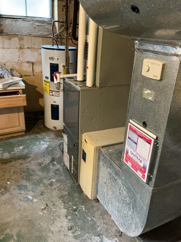 Conducted on-site evaluation of aging HVAC system including 23-year-old furnace and 13-year-old air conditioning unit in residential basement mechanical room. Documented existing equipment condition through detailed photographic assessment, noting furnace with standard metal ductwork configuration, PVC intake/exhaust venting, and adjacent water heater installation. Provided comprehensive replacement options and repair alternatives to homeowners for consideration, with follow-up consultation scheduled to finalize equipment selection and installation planning.