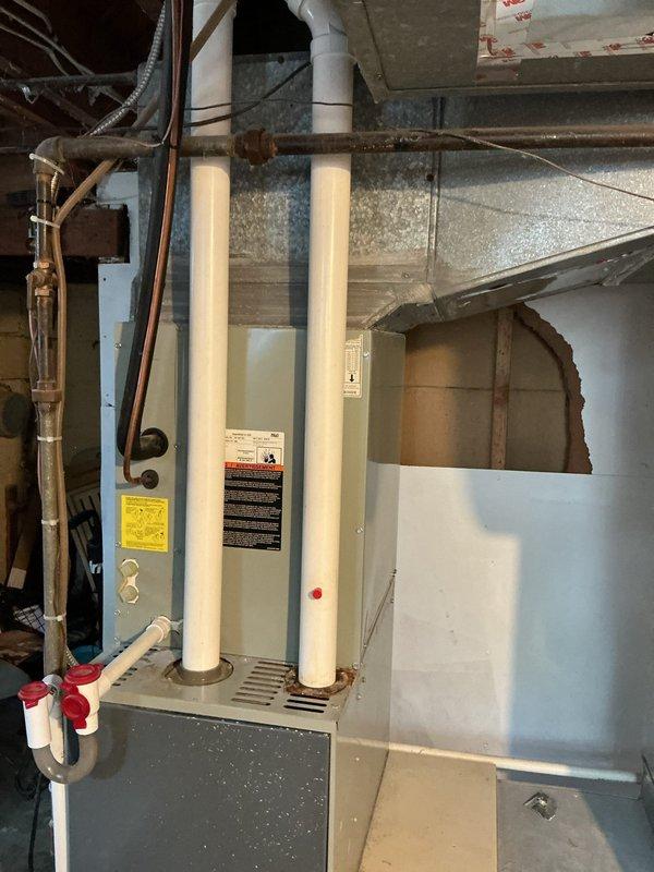 Conducted on-site evaluation of aging HVAC system including 23-year-old furnace and 13-year-old air conditioning unit in residential basement mechanical room. Documented existing equipment condition through detailed photographic assessment, noting furnace with standard metal ductwork configuration, PVC intake/exhaust venting, and adjacent water heater installation. Provided comprehensive replacement options and repair alternatives to homeowners for consideration, with follow-up consultation scheduled to finalize equipment selection and installation planning.