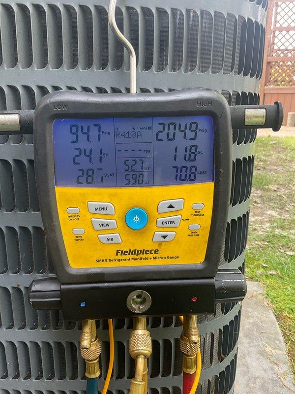 Completed comprehensive AC tune-up on 10-year-old residential air conditioning system. Performed full system inspection of indoor air handler and outdoor condensing unit, verified refrigerant pressures and temperatures using digital manifold gauges with readings showing 94.7 PSIG suction pressure with 24°F superheat and 204.9 PSIG discharge pressure at 118°F, indicating proper refrigerant charge and system operation. Inspected condenser coil condition, checked electrical connections, and confirmed all components functioning within manufacturer specifications. System operating efficiently with no issues identified or repairs required at time of service.