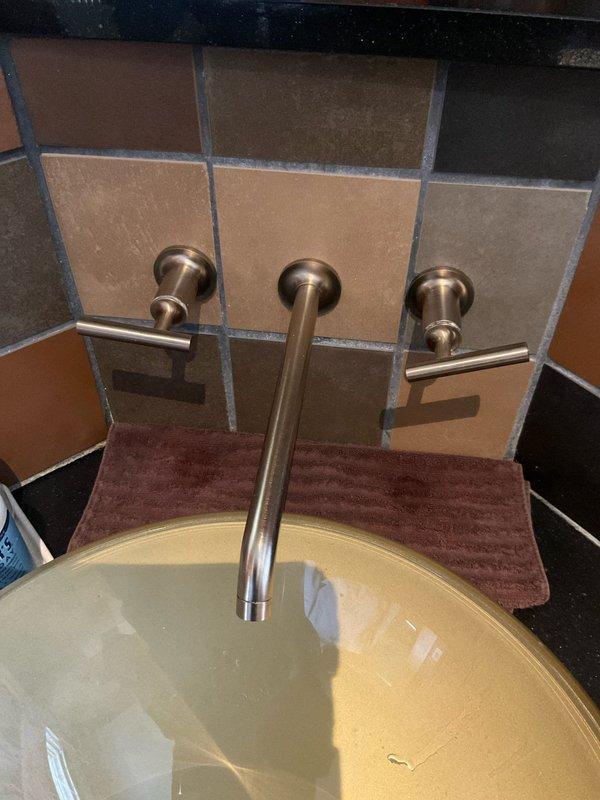 Responded to service call for multiple plumbing fixtures requiring repair. Addressed dripping faucets throughout the property, including the wall-mounted three-piece bathroom faucet assembly with dual lever handles and center spout. Diagnosed and corrected shower temperature fluctuation issue caused by pressure imbalance in the mixing valve. Repaired continuously running toilet by replacing faulty flapper valve and adjusting fill valve mechanism to restore proper water shutoff function.