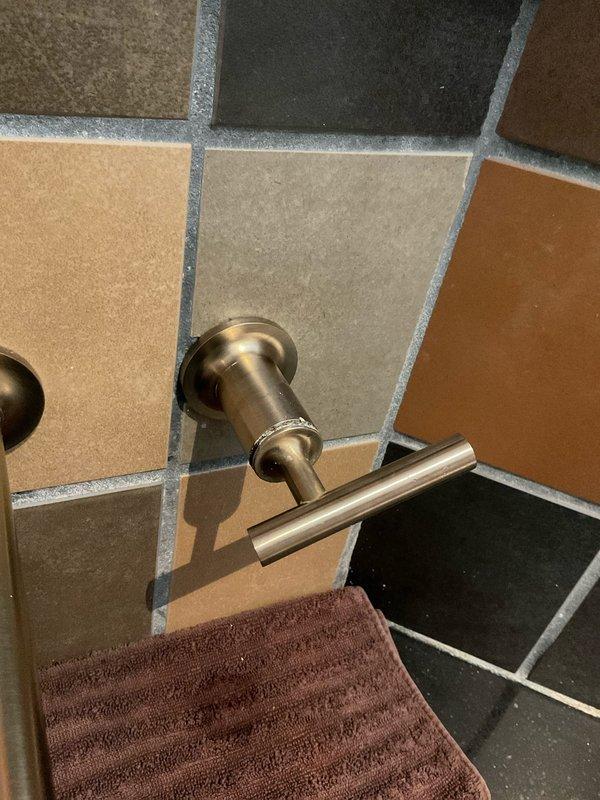 Responded to service call for multiple plumbing fixtures requiring repair. Addressed dripping faucets throughout the property, including the wall-mounted three-piece bathroom faucet assembly with dual lever handles and center spout. Diagnosed and corrected shower temperature fluctuation issue caused by pressure imbalance in the mixing valve. Repaired continuously running toilet by replacing faulty flapper valve and adjusting fill valve mechanism to restore proper water shutoff function.