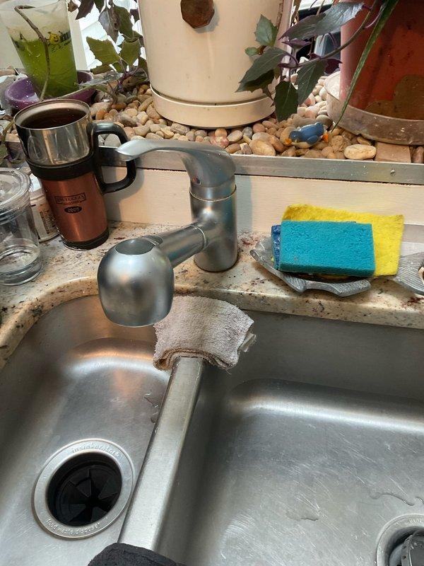 Completed professional installation of customer-supplied kitchen sink in granite countertop over a two-day service period. Installation included mounting stainless steel double-basin sink, installing modern single-handle pull-down faucet with brushed metal finish, and configuring complete under-sink plumbing assembly with garbage disposal unit, PVC P-trap drainage system, copper water supply lines, and shut-off valves. All components tested and verified operational upon completion.