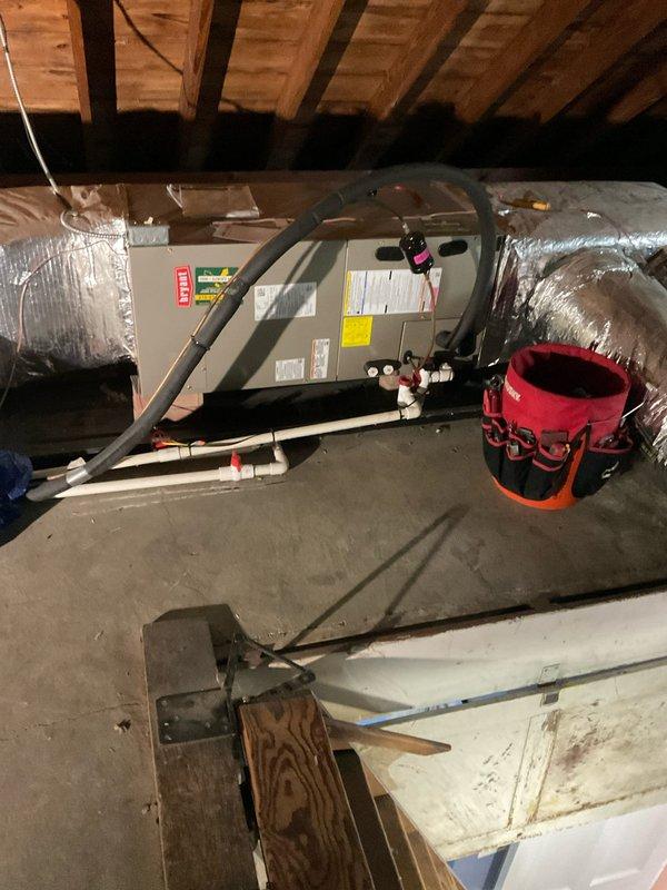 Performed preventative maintenance on two residential cooling systems: one outdoor condenser unit located in the backyard and one air handler unit installed in the attic space. Conducted temperature diagnostics on the outdoor unit, recording surface temperature readings of 54.5°F on the condenser pad. Inspected condenser coil fins, concrete pad condition, and overall exterior unit operation. In the attic, evaluated the air handler system including flexible ductwork connections, insulated refrigerant line sets, PVC condensate drainage system, and auxiliary condensate pump assembly. Verified proper installation of all components, checked insulation integrity on refrigerant lines, and confirmed condensate removal systems were functioning correctly. Both systems appeared operational with all major components accessible for routine service.