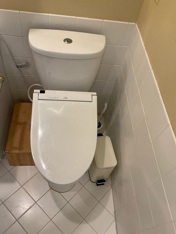 Responded to service call for toilet replacement evaluation. Upon arrival, inspected existing toilet with electronic bidet seat attachment and identified customer's request for replacement quote. Documented current installation including bidet functionality, water supply connections, shut-off valve condition, and floor mounting configuration. Assessed plumbing infrastructure behind fixture, noting flexible supply line connections to wall-mounted brass shut-off valves and existing floor conditions for potential replacement work. Photographed installation details to provide accurate replacement estimate including bidet seat considerations and any necessary plumbing modifications.