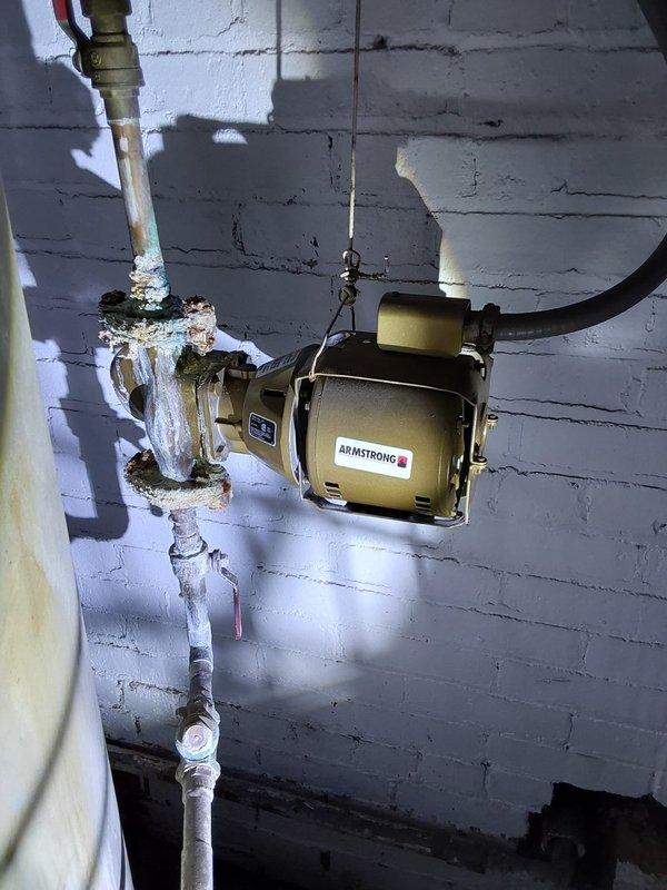 Provided quote for installation of new commercial-grade tanked water heater at commercial facility. Assessed existing mechanical room conditions, noting significant mineral buildup and efflorescence on current plumbing infrastructure including pump system and associated piping. Documented existing equipment configuration and utility space layout to determine proper sizing and installation requirements for replacement commercial water heater unit.