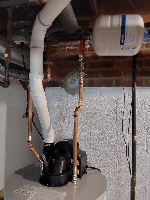 Responded to service call for leaking water heater at 60-year-old single-family residence. Upon inspection, diagnosed failed tank requiring complete replacement due to active leak. Removed existing deteriorated water heater and installed new Bradford White tanked unit with proper connections including copper supply lines, brass shut-off valves, temperature and pressure relief valve with discharge piping, and heat trap fittings. Completed all plumbing connections to manufacturer specifications, verified proper operation of circulator pump, ensured integration with existing water treatment system, and tested unit for leaks and proper heating function before completing service.