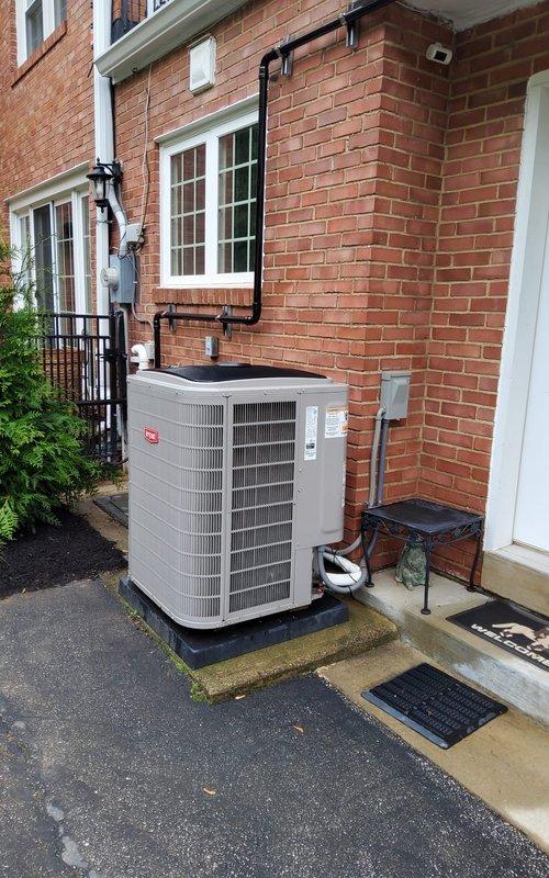 Completed scheduled cooling system tune-up on residential outdoor condensing unit. Performed comprehensive preventive maintenance inspection including visual assessment of equipment condition, electrical connections, refrigerant lines, and condensate drainage system. Unit exterior and installation verified to be in good working condition with proper clearances maintained around cabinet-style condenser, secure mounting on rubber isolation pad, and appropriate electrical disconnect box placement per code requirements.