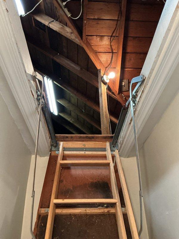 Conducted on-site assessment for mini split air conditioning installation on second floor of residence with hot water heat. Evaluated attic access and structural conditions, documenting exposed ceiling joists, existing insulation, and electrical routing to determine optimal placement for indoor and outdoor units compatible with customer's preference for non-automated controls.