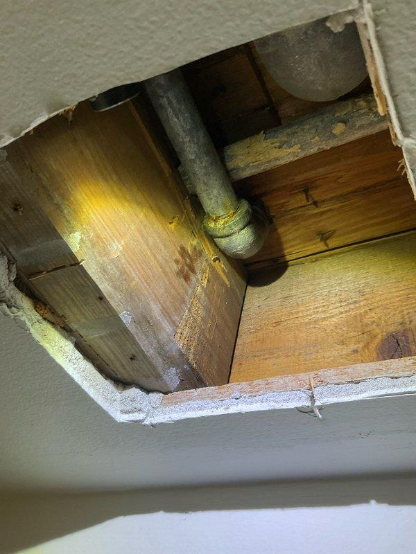 Opened wall in third floor stairwell to access and expose deteriorated galvanized hot water supply piping. Removed existing galvanized riser and replaced with new copper piping to restore proper water supply. Installed compression shutoff valve and escutcheon for code compliance and future serviceability. Tested system for leaks and verified proper operation of all fixtures.