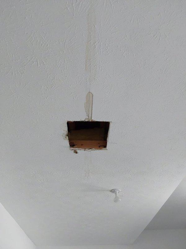 Responded to water leak investigation in 12-year-old residential property. Created access openings in ceiling and wall to inspect for moisture intrusion and plumbing system integrity. Cut exploratory openings in drywall to expose framing, sheathing, and concealed plumbing lines. Inspected cavity spaces, wooden framing members, and OSB sheathing for signs of active leaks, water damage, or deterioration. Documented findings with photographs showing access points and interior building components. No active leak source identified during inspection period; areas examined showed no visible water staining or moisture damage to structural elements at time of service.
