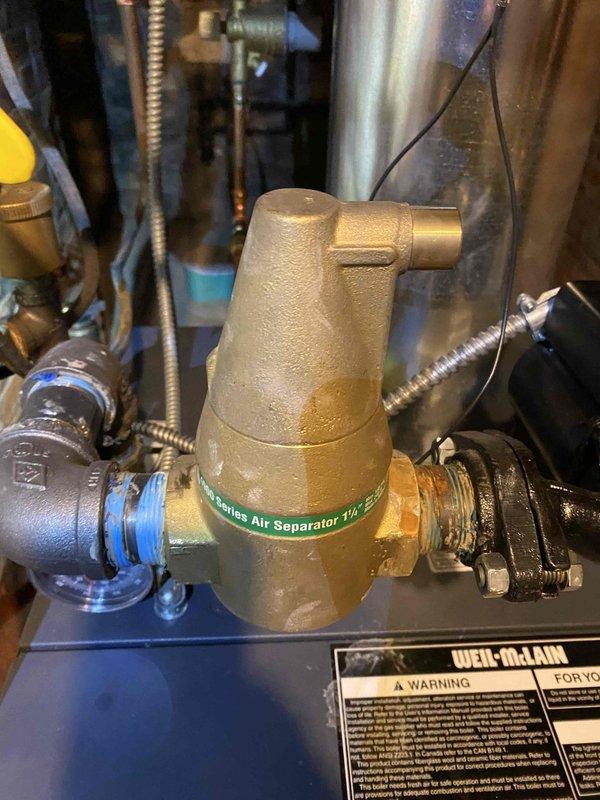 Responded to service call for boiler system that would not shut off. Upon inspection, identified malfunctioning zone valve as root cause preventing proper system cycling. The existing zone valve showed signs of age and wear despite the relatively new one-year-old Weil-McLain boiler installation. Measured and assessed copper piping connections to ensure proper sizing for replacement valve installation. Photographed air separator and system components for documentation. Replaced defective zone valve with new unit, restoring proper boiler operation and resolving continuous run condition. Tested system cycling to verify zone valve now opens and closes correctly in response to thermostat calls. System returned to normal operation with boiler shutting off as designed.
