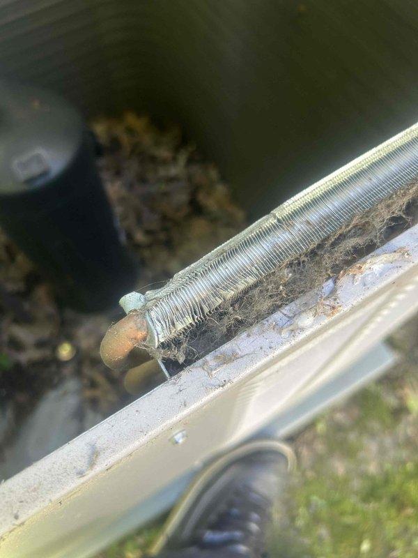 Performed preventative maintenance on 7-year-old residential air conditioning system. Inspected evaporator and condenser coils, noting significant accumulation of dirt, dust, and debris throughout the fin surfaces which can reduce heat transfer efficiency and system performance. Documented coil condition with photos showing heavy buildup between metal fins and on exterior surfaces, typical of outdoor equipment exposed to environmental elements without recent cleaning.