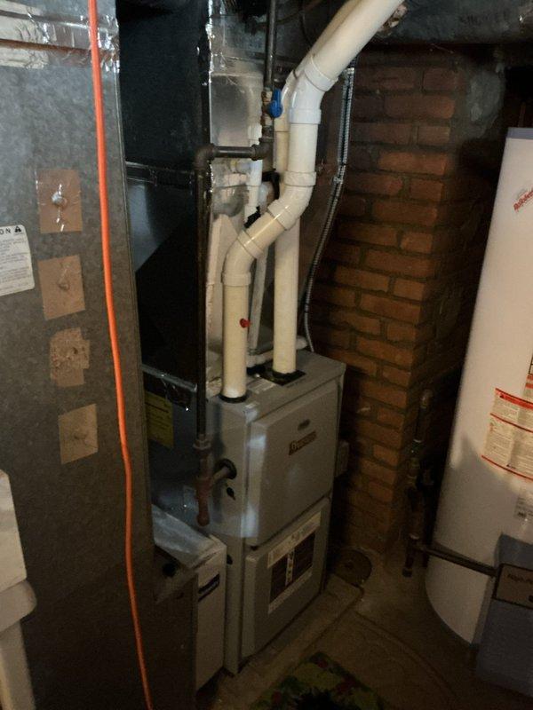 Conducted on-site evaluation for complete HVAC system replacement. Assessed existing two-stage furnace unit in basement mechanical room, noting current configuration with PVC venting system and connection to existing ductwork. Inspected exterior utility connections and identified weathered condensate drainage lines showing significant deterioration and staining. Documented equipment specifications, spatial constraints, and existing infrastructure to provide comprehensive replacement estimate options. Coordinated arrival time and confirmed appointment for presenting three equipment replacement proposals to customer.