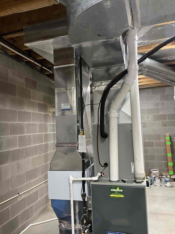 Conducted on-site evaluation for complete HVAC system replacement in residential basement mechanical room. Assessed existing ductwork configuration, heating equipment, and spatial requirements for new installation, documenting current system layout including suspended metal ductwork, PVC piping connections, and equipment positioning. Evaluated exterior access points and clearances for equipment removal and installation, photographed existing conditions to support replacement proposal specifications.