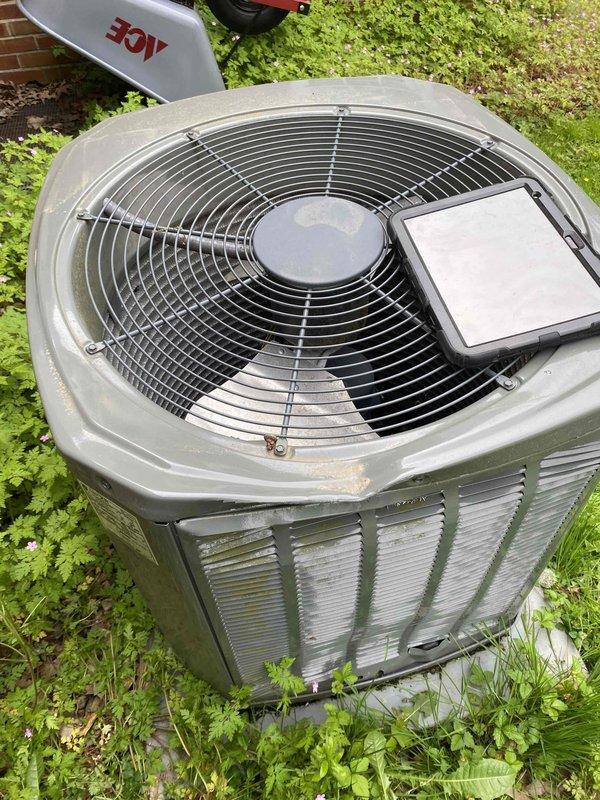 Responded to service call for outdoor condensing unit damaged by falling ice. Upon arrival, found condenser fan blade severely dented and fan motor operating improperly due to impact damage. Inspected top-mounted fan assembly and protective guard for structural integrity. Documented damage to fan blade and assessed unit for additional impact-related issues. Unit requires replacement of damaged condenser fan blade and motor verification to restore proper airflow and system operation.