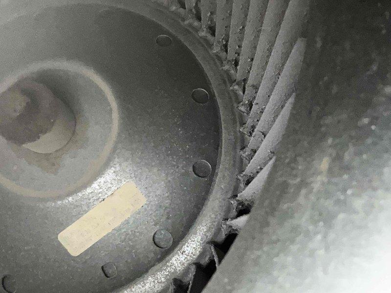 Performed comprehensive air conditioning tune-up on 15-year-old system including full inspection of blower assembly, which showed significant dust and debris accumulation on blower wheel fins and motor housing. Conducted combustion analysis and temperature differential measurements, recording supply air temperature of 330.5°F and achieving 15.7°F temperature split with CO2 levels at 0.66%, confirming proper system operation and efficiency within acceptable parameters.