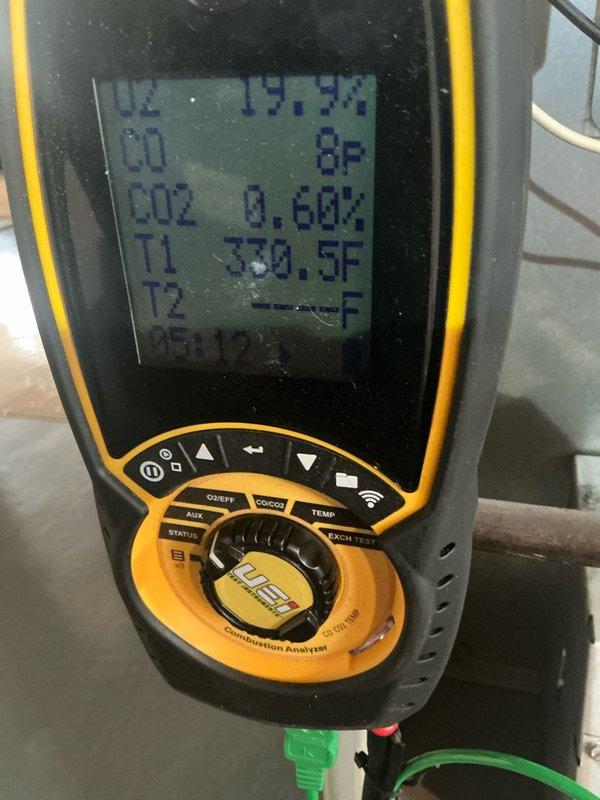 Performed comprehensive air conditioning tune-up on 15-year-old system including full inspection of blower assembly, which showed significant dust and debris accumulation on blower wheel fins and motor housing. Conducted combustion analysis and temperature differential measurements, recording supply air temperature of 330.5°F and achieving 15.7°F temperature split with CO2 levels at 0.66%, confirming proper system operation and efficiency within acceptable parameters.