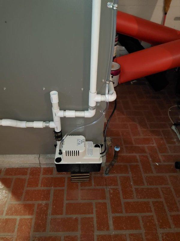 Installed new condensate pump with white PVC discharge piping to properly remove condensate from HVAC system. Replaced failed expansion tank on hydronic heating system to restore proper pressure control and system operation.