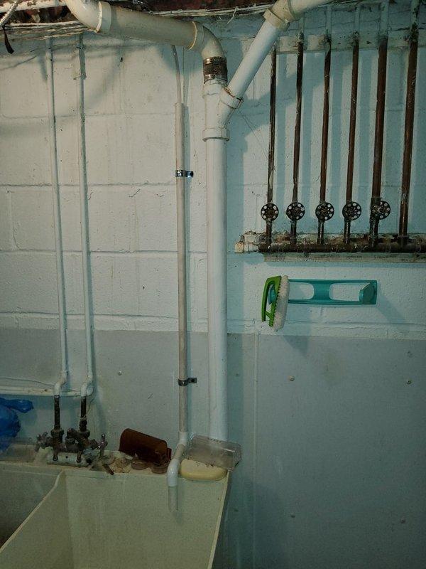 Installed new condensate pump with white PVC discharge piping to properly remove condensate from HVAC system. Replaced failed expansion tank on hydronic heating system to restore proper pressure control and system operation.