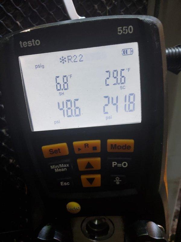 Responded to service call for 11-year-old air conditioning system reported as not running with no cooling and excessive condensation buildup on refrigerant lines. Upon arrival, performed diagnostic evaluation using digital manifold gauges on R22 system. Measured operating pressures and temperatures, recording suction pressure at 48.5 psi with superheat of 68°F and discharge pressure at 241.0 psi with subcooling of 296°F on initial readings. Conducted secondary pressure analysis showing 470 psi and 222.0 psi with temperature readings of 23°F and 10.8°F. Observed significant condensation accumulation on refrigerant line set as reported. System was found running at time of service. Documented system conditions with digital pressure/temperature readings for service records.