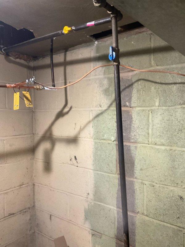 Installed new outdoor spigot and replaced kinked copper water line to refrigerator with flexible supply line. Work completed in basement utility area with all connections properly secured and tested for leaks.