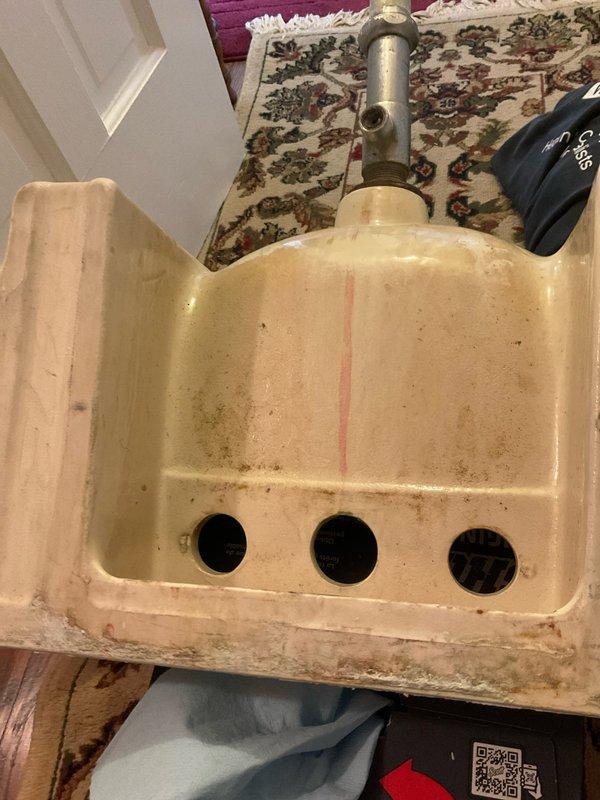 Replaced shelf-mounted faucet assembly in vintage bathroom with peachy-pink tile work. Removed existing worn fixture, installed new faucet hardware, and conducted thorough testing to verify proper water flow and drainage functionality.