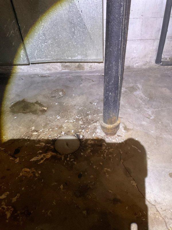 Responded to a clogged water line in the basement resulting in significant standing water and flooding. Upon arrival, located the property using the exterior post light as directed and assessed the basement area where water had accumulated on the concrete floor with visible sediment and debris. Cleared the clogged drain line and restored proper water flow through the system. Verified drainage function was operating correctly before completing the service call.