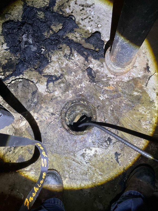 Responded to a clogged water line in the basement resulting in significant standing water and flooding. Upon arrival, located the property using the exterior post light as directed and assessed the basement area where water had accumulated on the concrete floor with visible sediment and debris. Cleared the clogged drain line and restored proper water flow through the system. Verified drainage function was operating correctly before completing the service call.