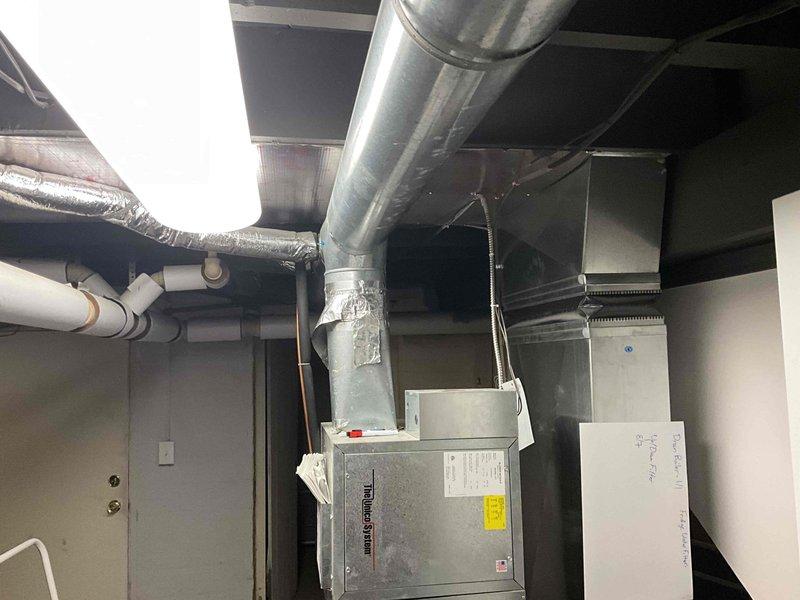 Performed routine air conditioner tune-up on residential HVAC system located in basement mechanical room. Accessed unit via exterior basement entrance, conducted comprehensive inspection of AC components, verified system operation, and documented equipment condition through photographic records. No issues identified during inspection; system operating within normal parameters.
