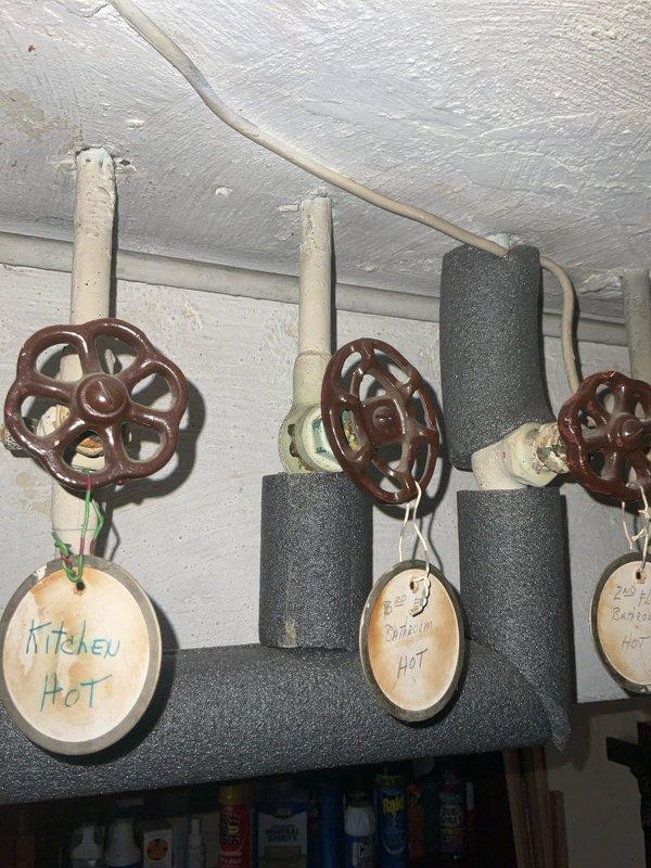 Responded to service call for installation of shut-off valves on copper supply lines. The existing copper tubing was soldered without individual fixture isolation valves. Installed new shut-off valves with wheel handles on hot water supply lines serving kitchen and bathroom fixtures. Valves were properly labeled with identification tags indicating "Kitchen Hot" and "Bathroom Hot" for easy identification. Applied foam pipe insulation to two of the supply lines to prevent heat loss and condensation. All connections were secured and tested for proper operation and leak-free performance, providing individual shut-off capability for each fixture zone.