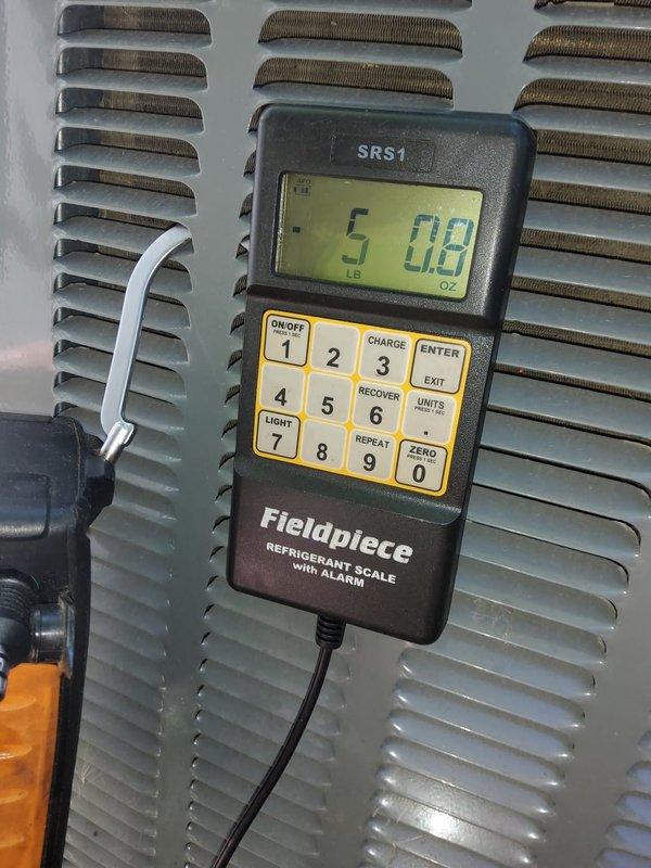 Responded to service call for 9-year-old central air conditioning system with Unico ductwork that was unable to cool residence below 76 degrees despite extended runtime. Upon arrival, accessed attic-mounted air handler and inspected system components including ductwork and refrigerant levels. Performed refrigerant charge verification using calibrated Fieldpiece scale, identifying system was low on refrigerant charge at 5 pounds 8 ounces. Added refrigerant to manufacturer specifications, verified proper system operation, and confirmed adequate cooling capacity restored to unit.