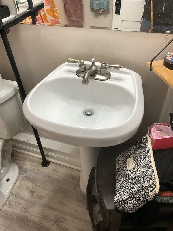 Repaired leaky dual-handle faucet on bathroom pedestal sink and replaced faulty diverter valve in bathtub shower assembly to restore proper water flow between tub spout and shower head. All fixtures tested and verified to be functioning correctly with no leaks upon completion.