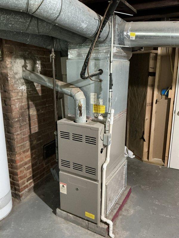 Conducted comprehensive HVAC system evaluation for equipment replacement estimate. Assessed existing gas furnace installation in basement utility area, documenting current equipment condition, ductwork configuration, and supply register locations throughout the residence. Evaluated plenum connections, existing duct insulation, and overall system layout to provide accurate replacement recommendations and specifications.