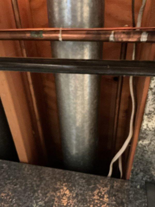 Conducted site assessment for kitchen remodeling estimate with plumbing requirements. Documented extensive water damage to ceiling surfaces showing discoloration, staining, and deterioration requiring remediation prior to remodeling work. Inspected existing copper supply lines, corroded valves, and pipe fittings in affected areas, photographing conditions of plumbing infrastructure, structural framing, and mechanical components to provide accurate scope of work for comprehensive kitchen renovation project.