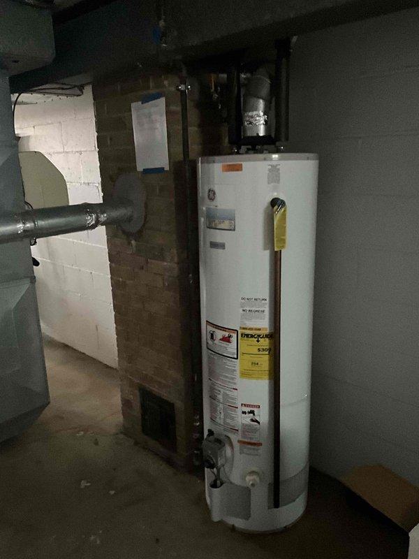 Conducted on-site evaluation for hyper heat ducted mini-split heat pump system installation. Customer specifically requested heat pump only configuration and declined dual fuel system option. Assessed existing HVAC infrastructure including aged outdoor condenser unit and basement mechanical room with water heater and brick chimney structure to determine optimal equipment placement and ductwork routing for new hyper heat system.