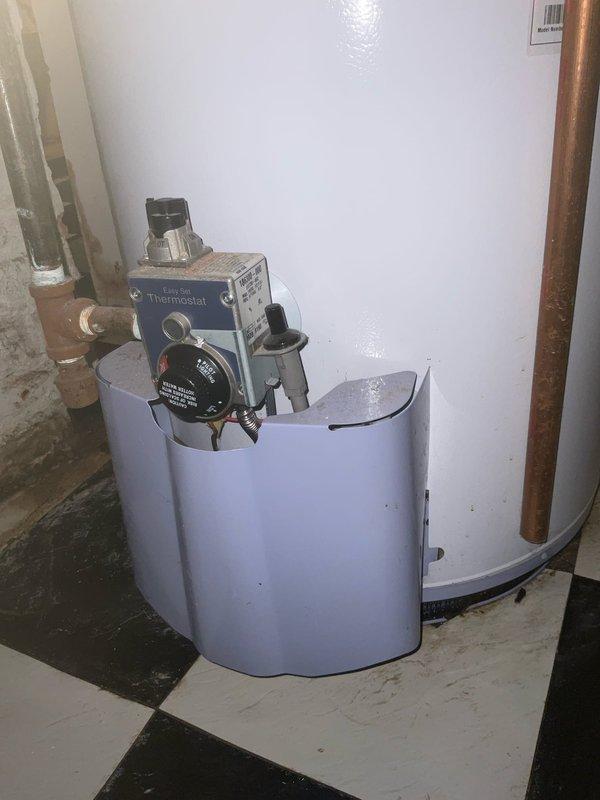 Responded to emergency service call for actively leaking tanked water heater in 9-year-old residence. Upon arrival, inspected gas-fired water heater unit and identified source of active leak from tank body, indicating internal tank failure. Confirmed customer had shut off water supply and gas valve as safety precaution. Documented existing conditions with photographs showing water heater installation, gas control valve assembly, copper supply line connections, and evidence of water damage on concrete floor. Evaluated temperature and pressure relief valve, gas connections, and overall system configuration. Advised customer that tank replacement would be necessary due to internal corrosion and tank integrity compromise. Also assessed reported minor leak at kitchen sink fixture for future repair consideration.