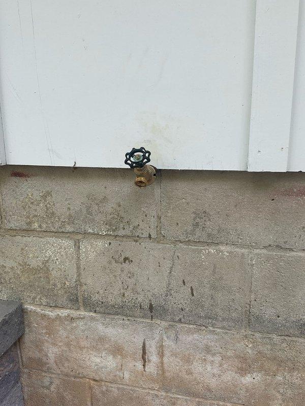 Responded to a leak at an exterior hose bib on a 55-year-old home. Replaced the deteriorated brass exterior faucet with a new frost-free sillcock and installed a new quarter-turn ball valve on the interior supply line to provide reliable shutoff capability. The original valve showed significant corrosion and the exterior spigot had failed at the packing, causing water seepage at the foundation level. Removed the old fixtures, properly sized and installed the new components, tested for leaks, and verified proper operation of both the exterior faucet and interior shutoff valve.