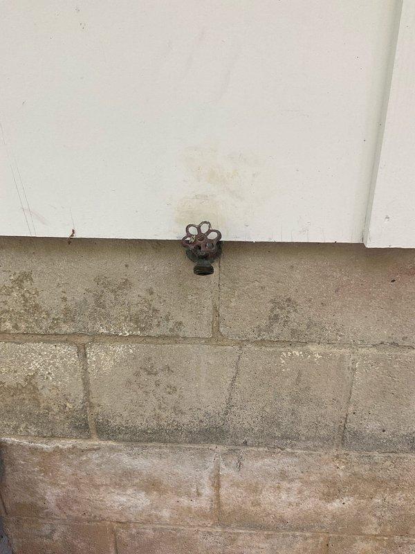 Responded to a leak at an exterior hose bib on a 55-year-old home. Replaced the deteriorated brass exterior faucet with a new frost-free sillcock and installed a new quarter-turn ball valve on the interior supply line to provide reliable shutoff capability. The original valve showed significant corrosion and the exterior spigot had failed at the packing, causing water seepage at the foundation level. Removed the old fixtures, properly sized and installed the new components, tested for leaks, and verified proper operation of both the exterior faucet and interior shutoff valve.