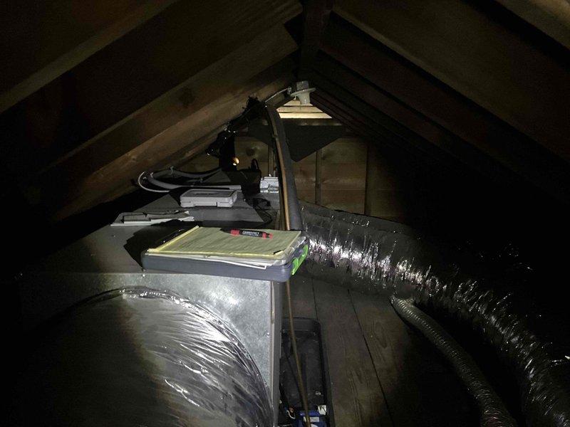 Conducted on-site assessment for mini split system replacement in residential attic space. Documented existing HVAC air handler unit and associated ductwork configuration, including flexible black ducting and metal components. Evaluated attic installation conditions, structural support, and current system placement for replacement planning. Photographed equipment positioning, ductwork routing, and available workspace to develop comprehensive replacement estimate.