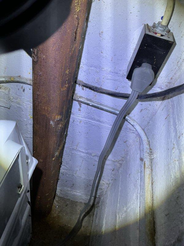 Responded to water leak under kitchen sink. Upon inspection, identified corroded metal supply piping in basement area showing advanced rust deterioration and potential leak source. Examined under-sink plumbing including P-trap assembly, dual shut-off valves with braided stainless steel supply lines, and Moen 1/3 HP garbage disposal unit. All cabinet-level connections and fittings appeared secure with no active leaking at trap or disposal connections. Documented conditions with photos showing aging infrastructure and recommended monitoring corroded basement piping for replacement to prevent future failures.