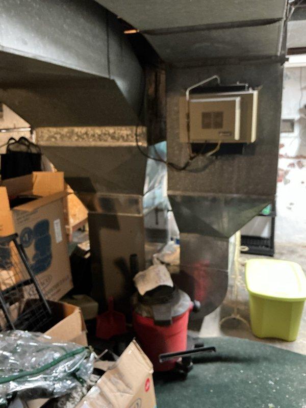 Responded to service call for non-cooling air conditioning system. Upon arrival, evaluated 20-year-old residential AC system including outdoor condenser unit and indoor components. Conducted thorough assessment of existing equipment condition and performance capabilities. Documented current system configuration with outdoor condenser unit located on exterior wall and indoor air handling equipment in basement utility area. Provided comprehensive estimate for complete HVAC system replacement due to age and inefficiency of existing equipment. Discussed replacement options and system specifications with homeowner.