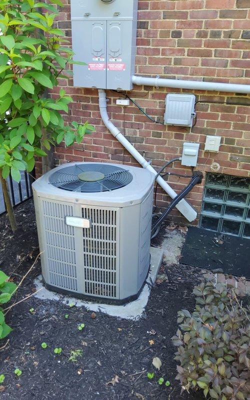 # HVAC Service Call - No Cooling Issue

Responded to service call for residential air conditioning system with outdoor unit running but no cold air delivery to interior spaces. Upon arrival, confirmed condenser unit fan motor operating normally with proper rotation observed at outdoor equipment location.

Performed comprehensive system diagnostics on Goodman model AUH1B060A9H31BA unit manufactured November 2016. Conducted visual inspection of outdoor condenser unit positioned on concrete pad against brick exterior wall. Verified electrical connections at wall-mounted disconnect panel and traced PVC conduit routing from electrical service to equipment. Examined indoor air handler specification label and recorded unit model and serial number for service documentation.

Diagnostic testing revealed system operational issues preventing proper cooling cycle. Checked refrigerant pressures, electrical voltages at unit terminals, and capacitor performance on both fan motor and compressor circui