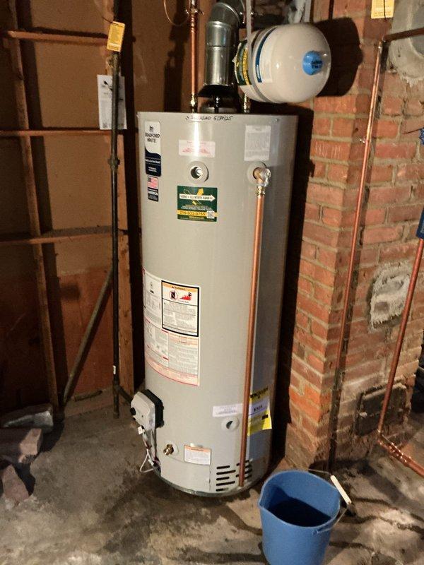 Performed annual maintenance tune-up on one-year-old Bradford White tanked water heater including flush and fill procedure. Accommodated site conditions with drain located approximately 15 feet from unit. Inspected all connections, copper piping, expansion tank, pressure relief valve assembly, and water treatment components; verified proper operation of all systems and left unit in excellent working condition.